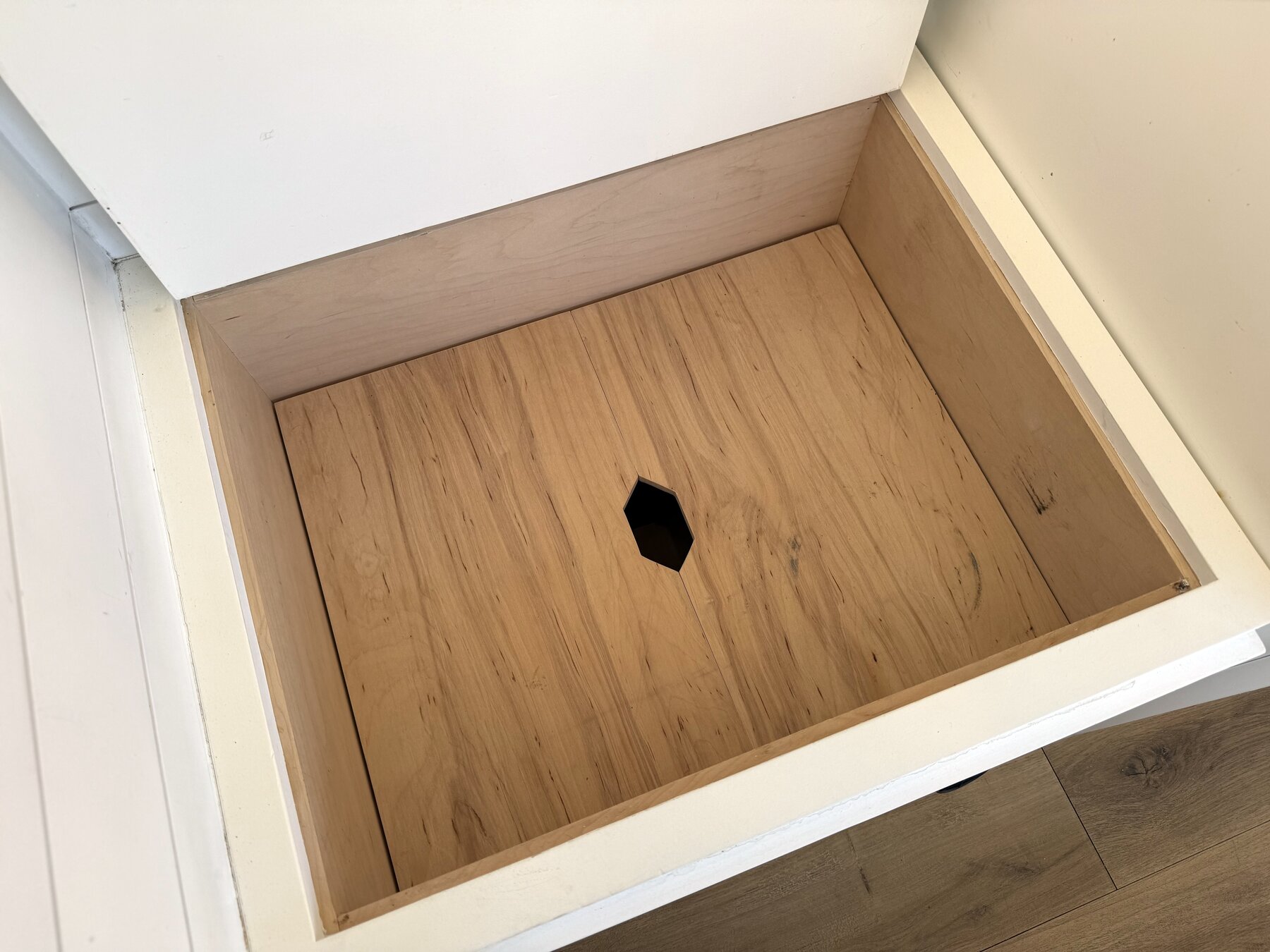 Storage compartment under a bench seat lid