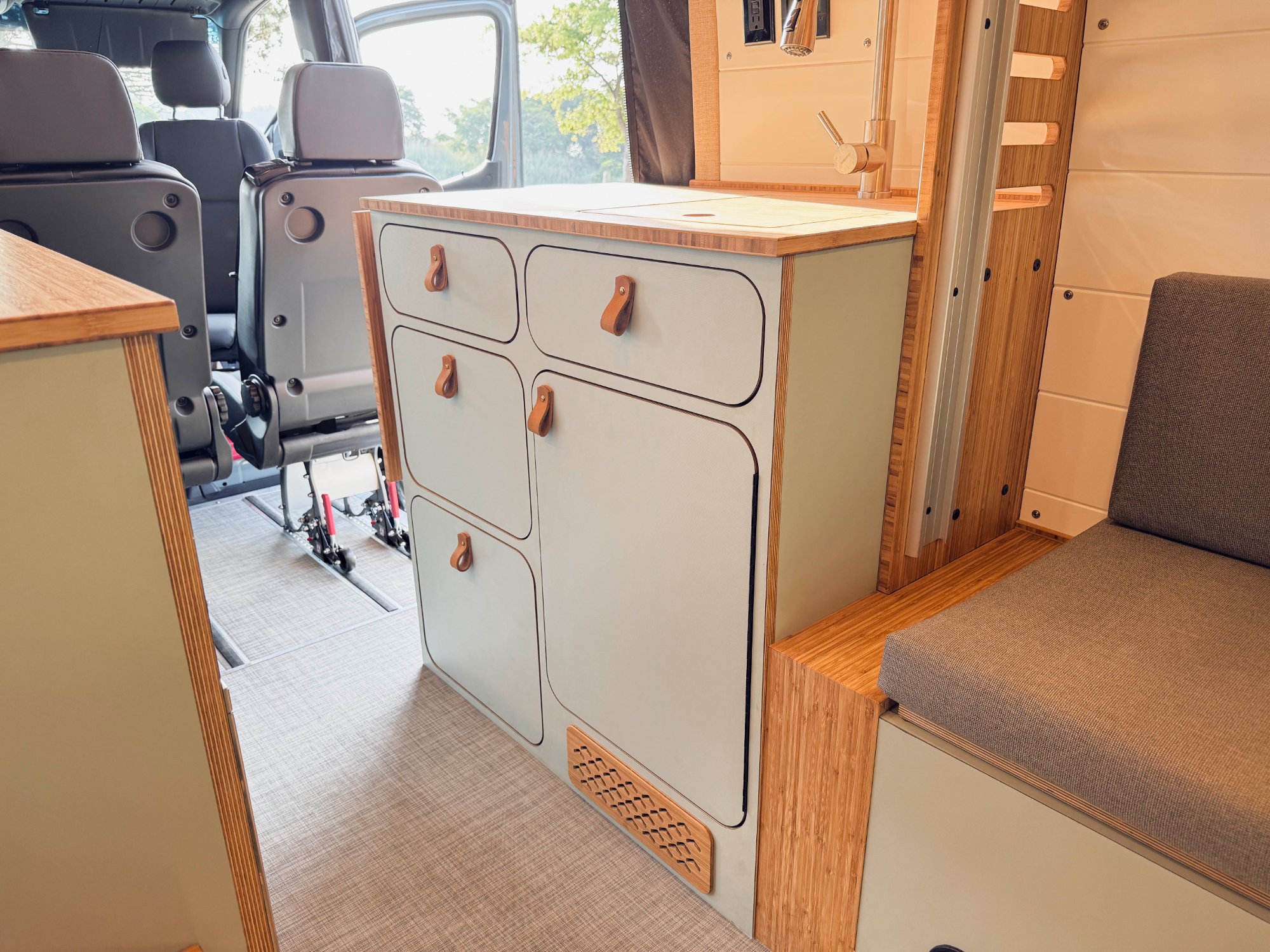 Sprinter cabinetry with leather pulls — closest match to Drift Wood sage cabinetry palette