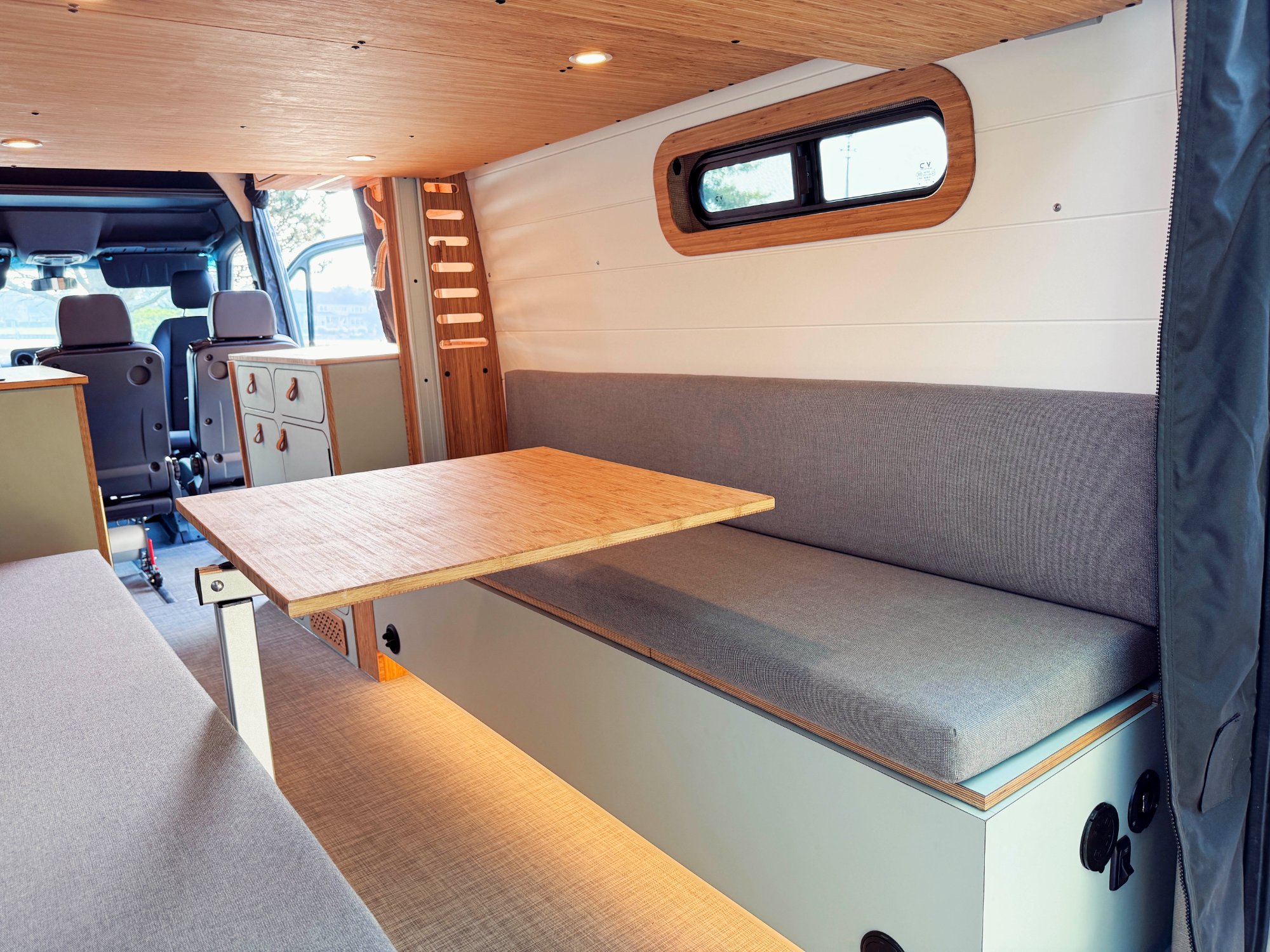 Sprinter bench seating with table — placeholder for Drift Wood lounge entertaining setup