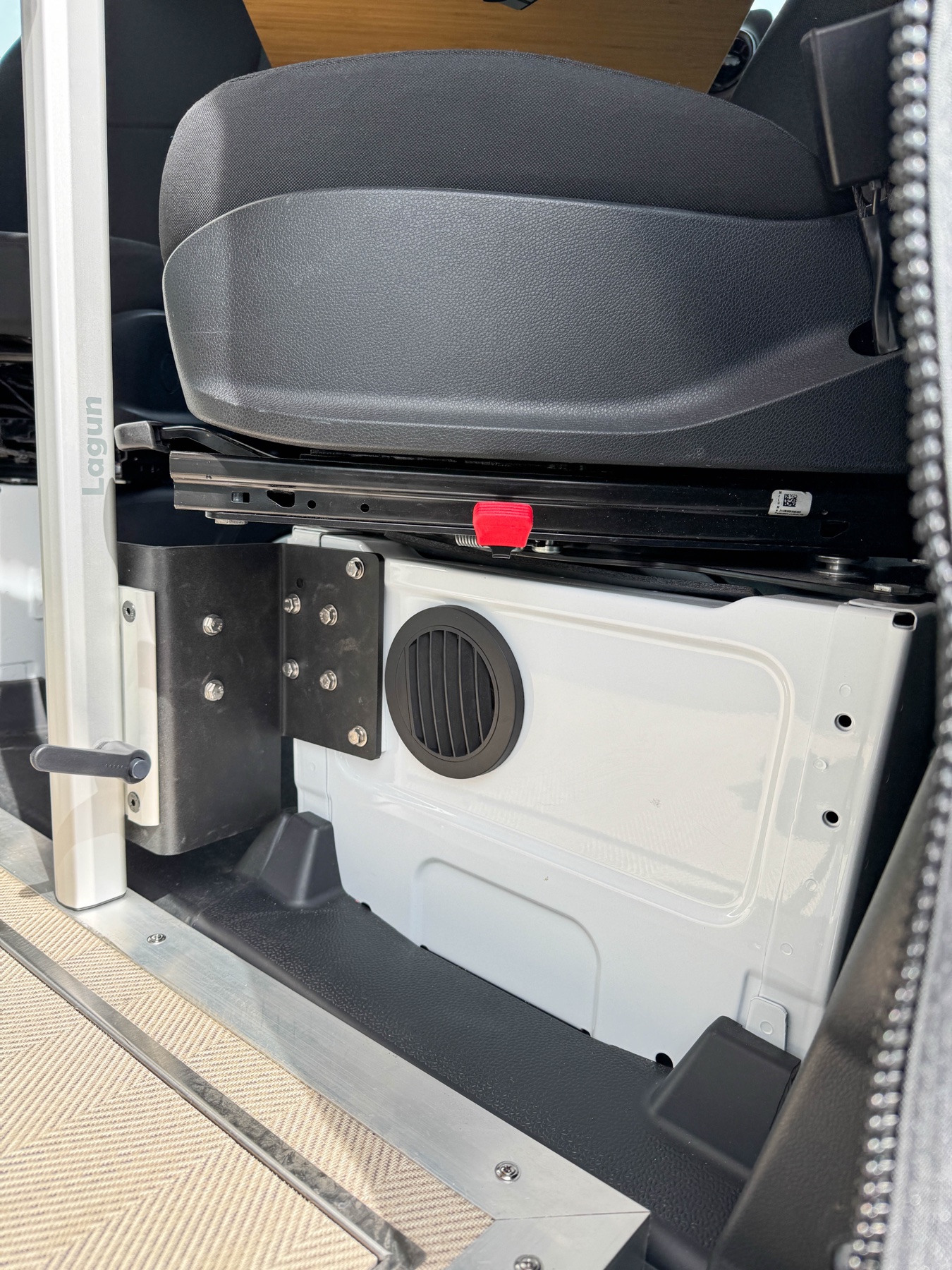 Diesel heater vent integrated at cab seat base for cold-weather heating