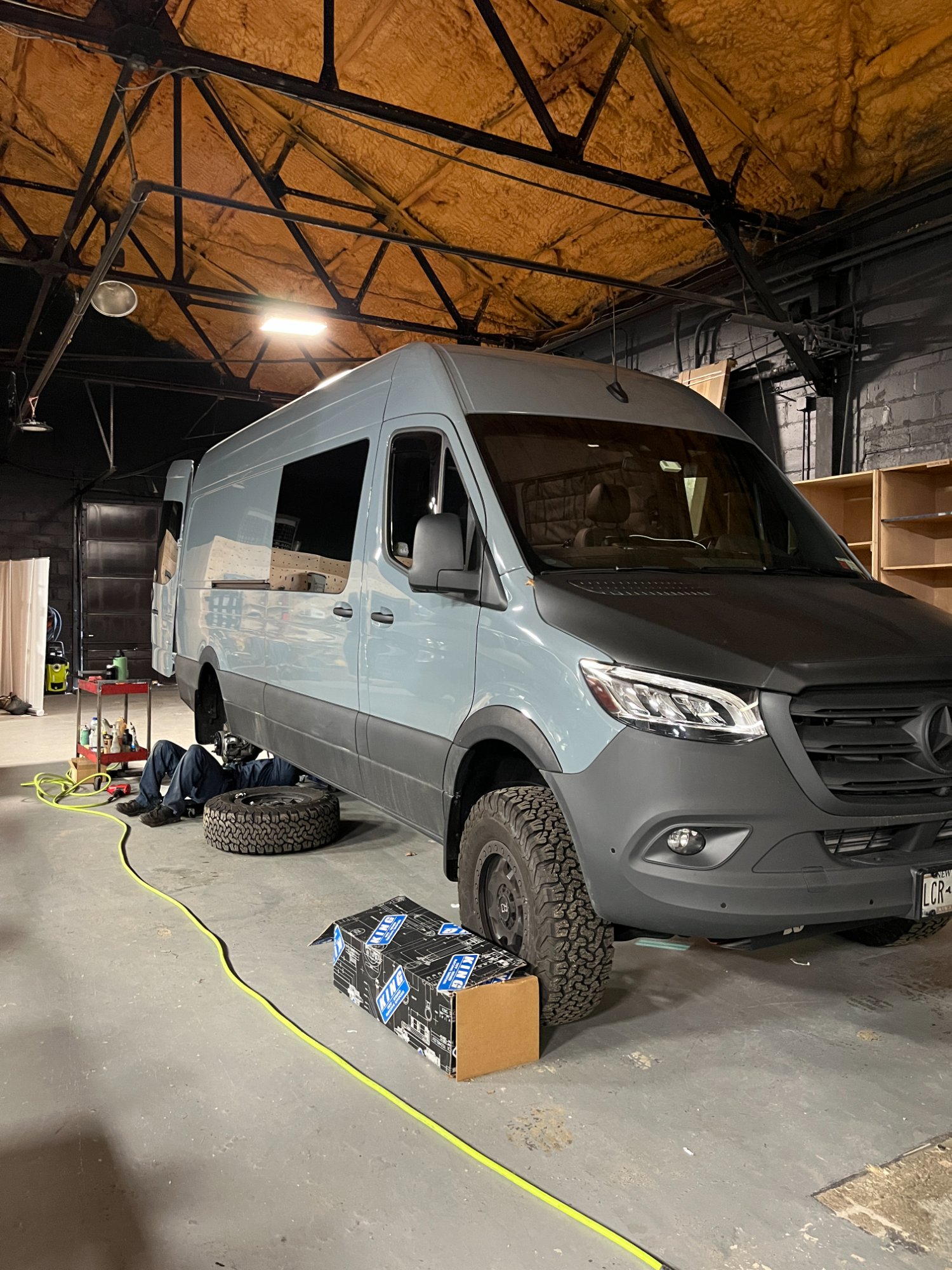 All-terrain tire being mounted on a Sprinter 4x4 van wheel in the Sequoia and Salt shop