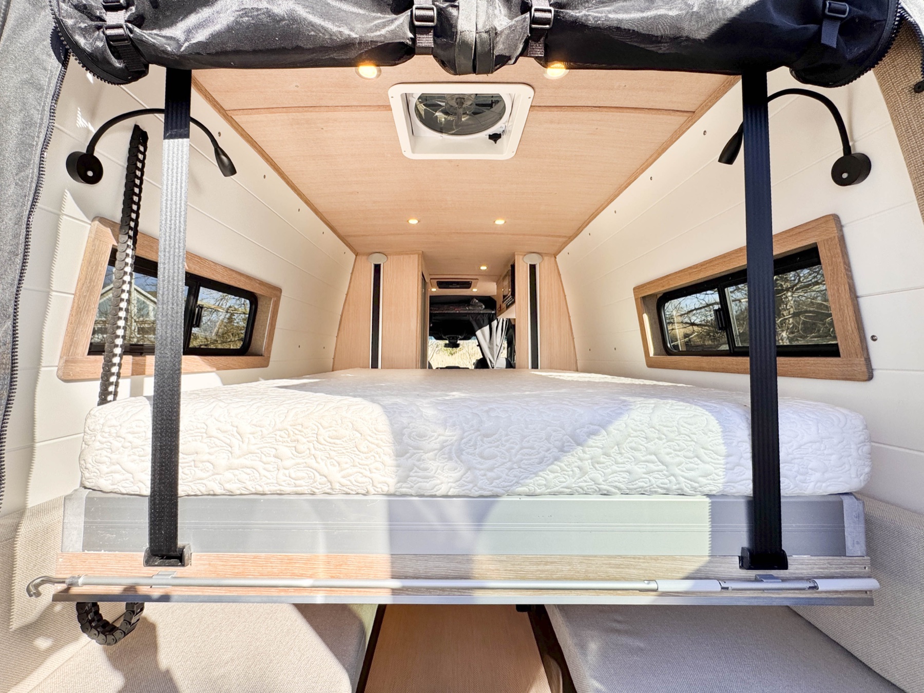 Loft campervan — rear view showing the two-mode lift-bed-over-lounge layout