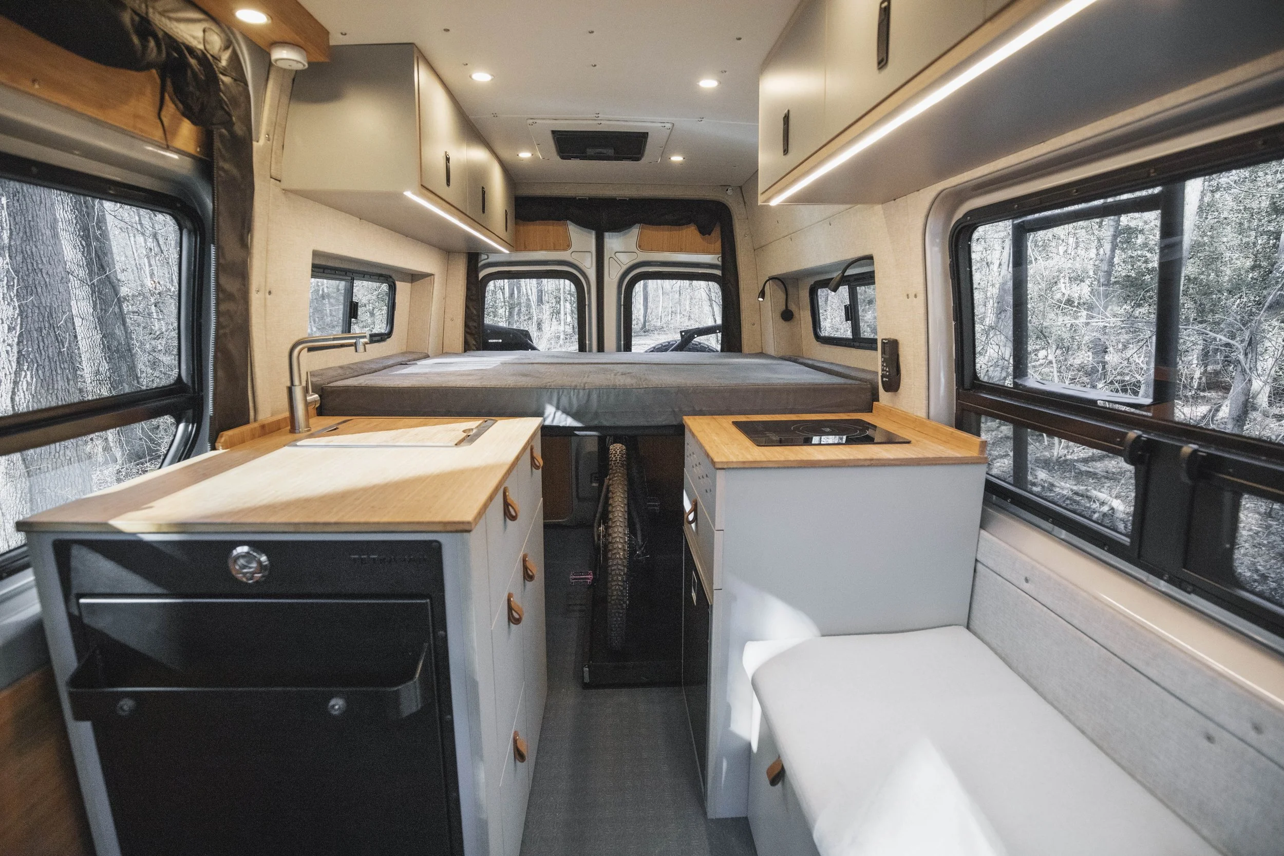 Scout campervan interior — kitchen and fixed bed