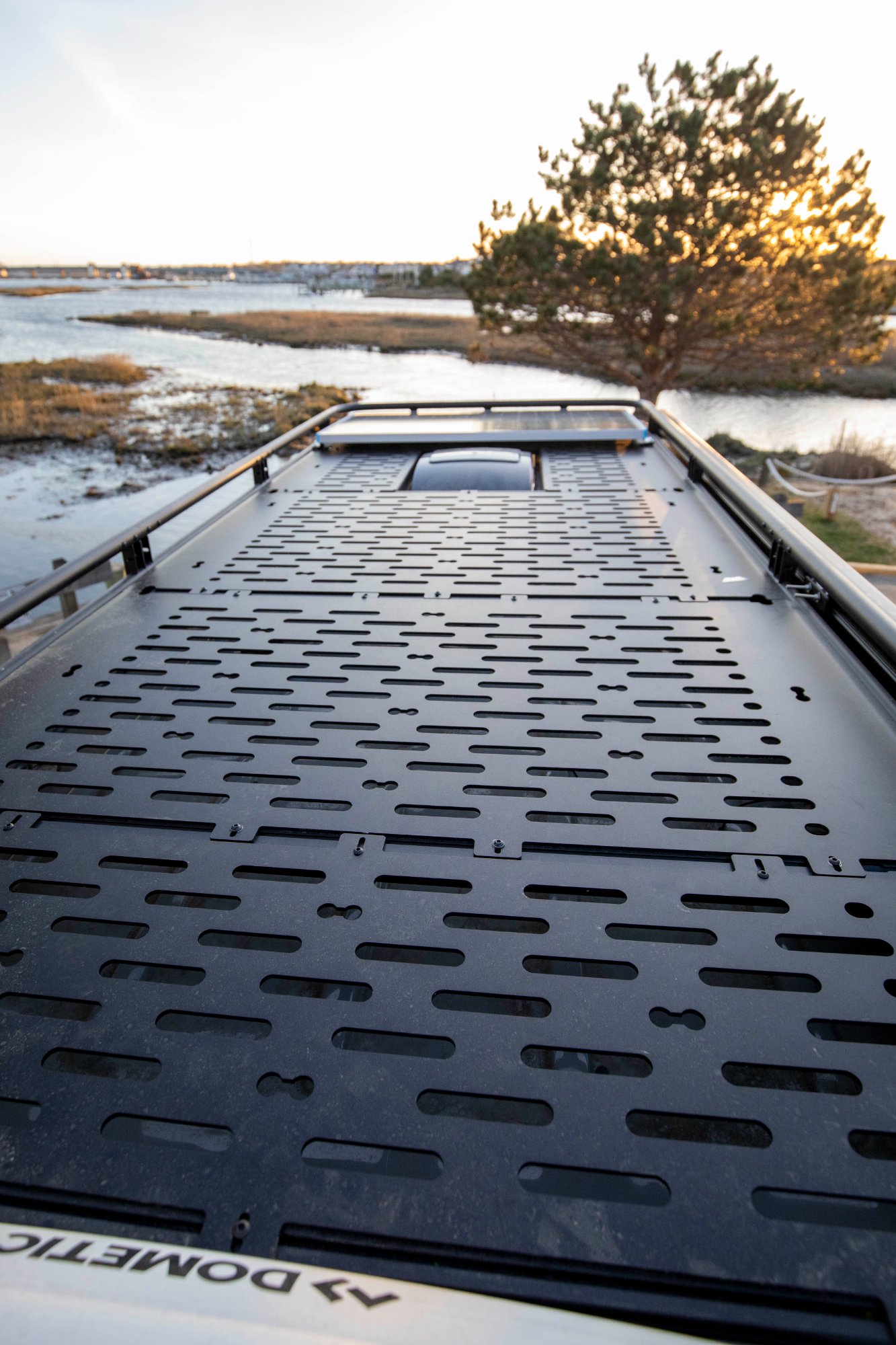 Scout campervan with roof rack at sunset