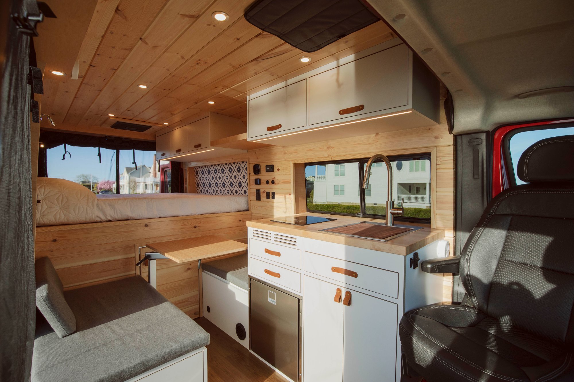 Full interior from cab — kitchen, dinette, sleeping platform